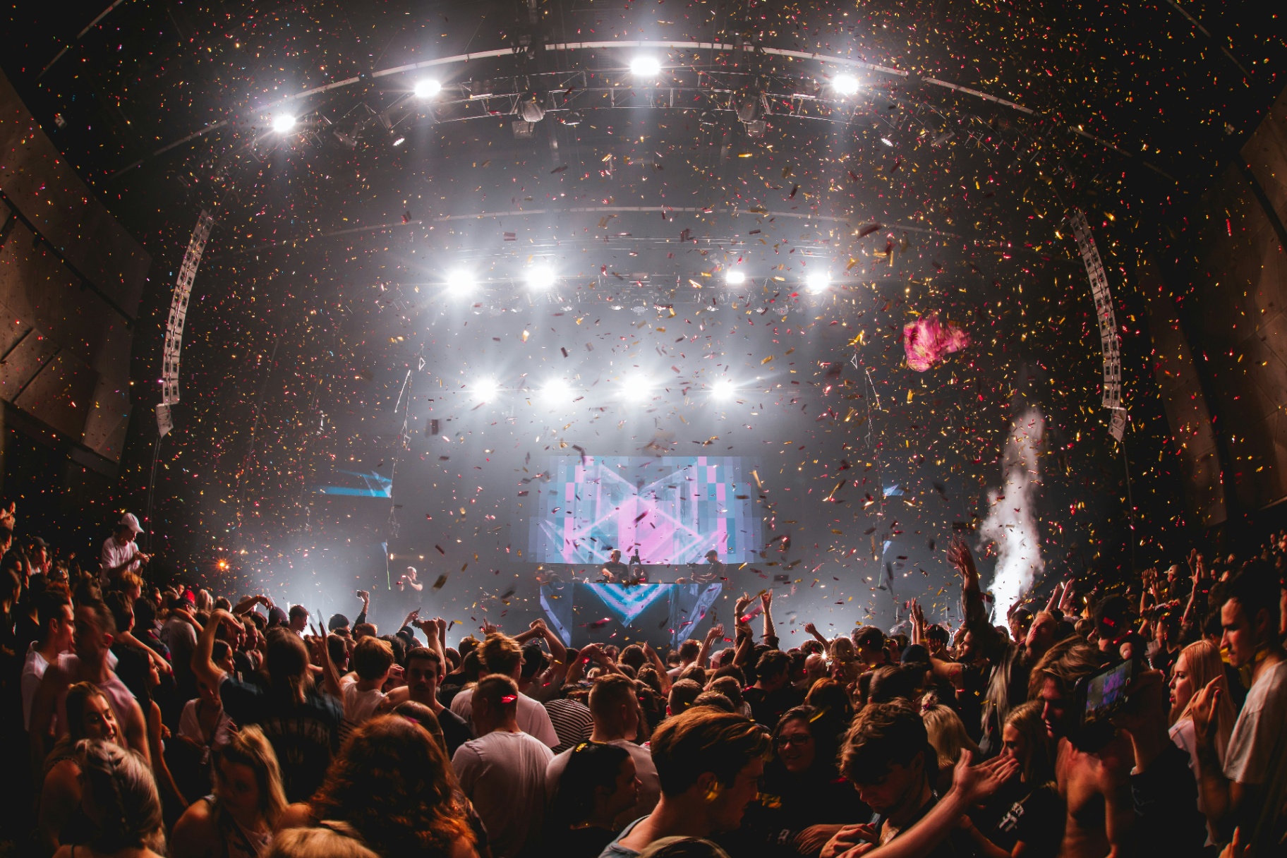 Cinematic concert venue with stage lights and crowd